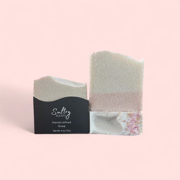 Sultry Scents luxury salt bar soap with white and blush layers and decorative pink salt crystals in black sleeve