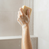 Person using natural Colloidal Oats goat milk Manuka honey soap for a gentle shower experience