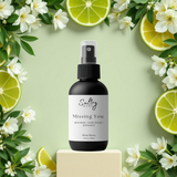 Sultry Scents body spray bottle on pedestal with citrus and jasmine accents Phlur Missing Person inspired body spray
