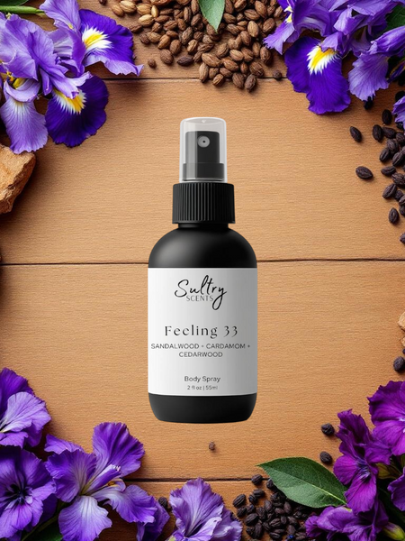 Sultry Scents Santal 33 inspired body spray Feeling 33 black spray bottle on wood surrounded by purple irises sandalwood and beans