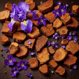 Sultry Scents Santal 33 inspired body spray displayed with sandalwood chips and purple flowers
