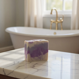 Soft Touch Goat Milk and Silk Soap Bar with a Swirled Purple and White Design on a Marble Counter