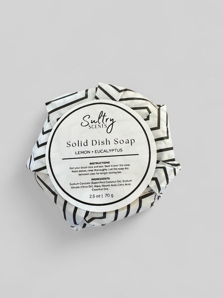 Sultry Scents solid dish soap lemon eucalyptus wrapped in black and white striped paper packaging