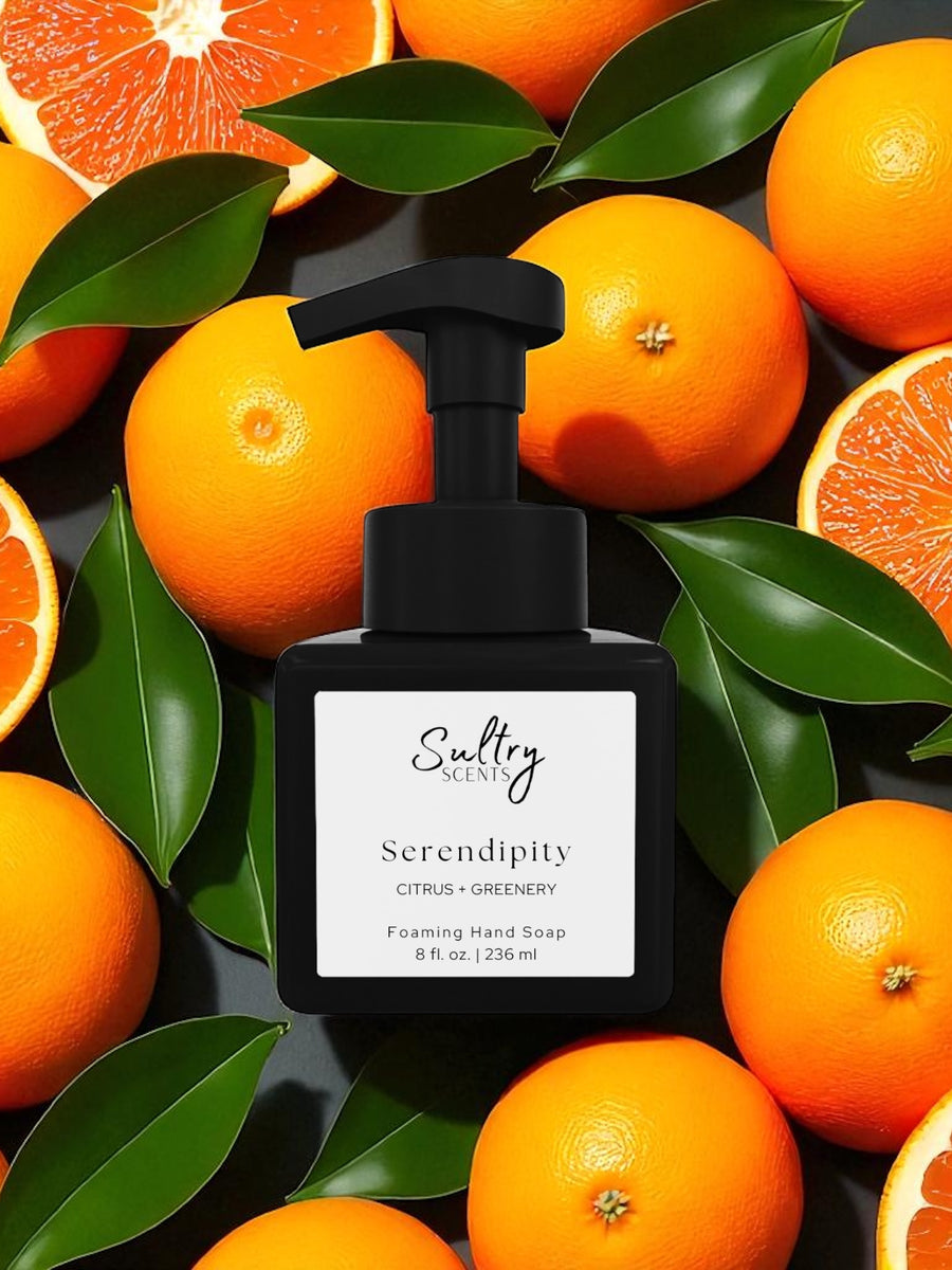 Sultry Scents Serendipity black foaming soap bottle surrounded by oranges and green leaves Volcano inspired foaming hand soap