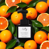 Sultry Scents Serendipity black foaming soap bottle surrounded by oranges and green leaves Volcano inspired foaming hand soap