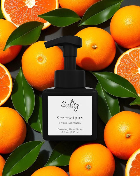 Sultry Scents Serendipity black foaming soap bottle surrounded by oranges and green leaves Volcano inspired foaming hand soap