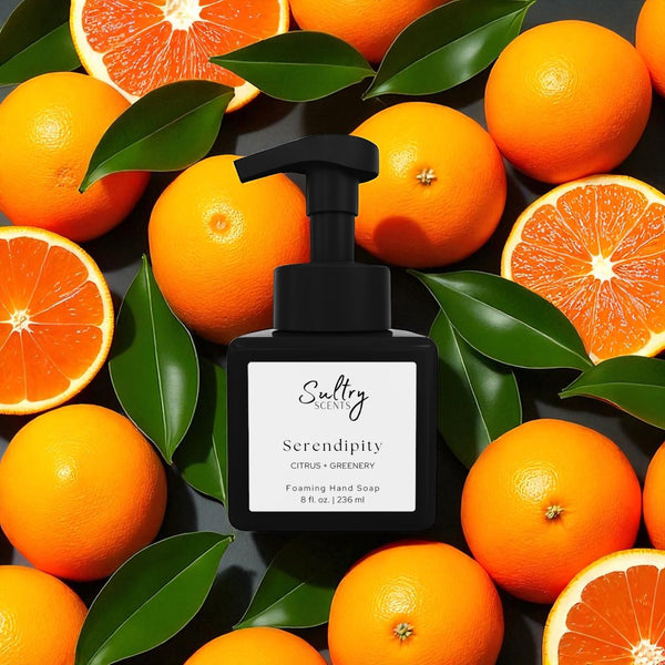Sultry Scents Serendipity black foaming soap bottle surrounded by oranges and green leaves Volcano inspired foaming hand soap