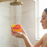 Person using Westin hotel inspired soap bar under a rain shower for a luxurious bathing experience