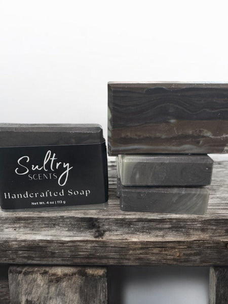 Sultry Scents handcrafted wood fragrance soap bars stacked on rustic wood for a natural aesthetic