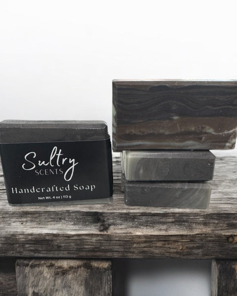 Sultry Scents handcrafted wood fragrance soap bars stacked on rustic wood for a natural aesthetic