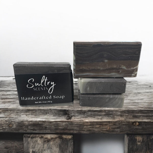 Sultry Scents handcrafted wood fragrance soap bars stacked on rustic wood for a natural aesthetic