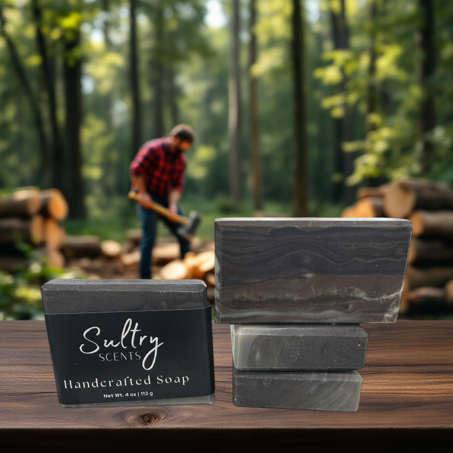 Sultry Scents wood fragrance soap stacked on wooden table in a forest setting