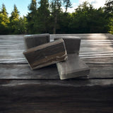 Handcrafted wood fragrance soap that looks like wood, displaying natural earthy tones and textures on a rustic table.