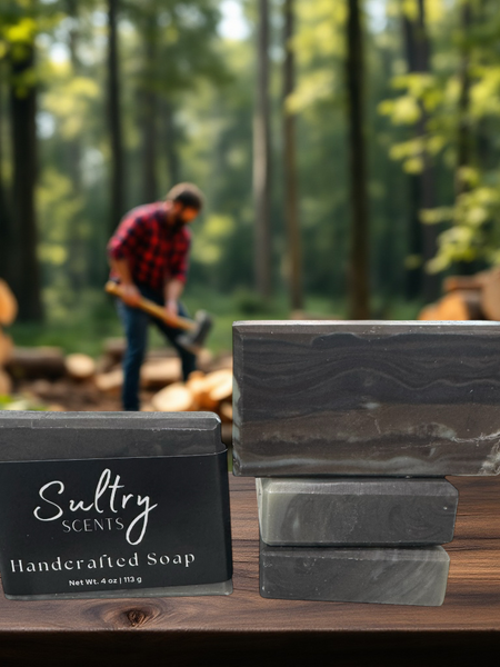 Sultry Scents wood fragrance soap that looks like wood displayed in a forest setting with logs