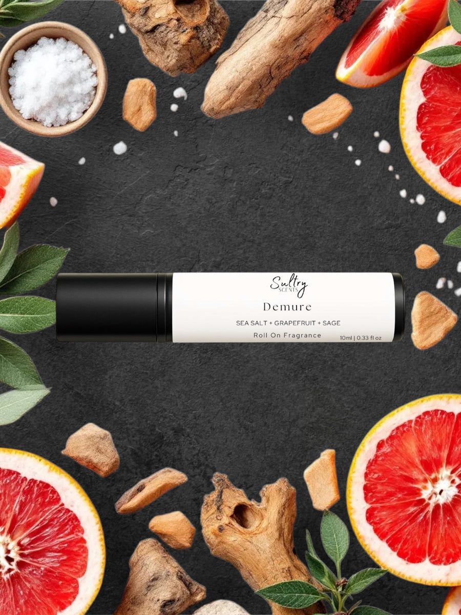 Sultry Scents wood sage and sea salt inspired roll on fragrance bottle surrounded by grapefruit slices and sea salt