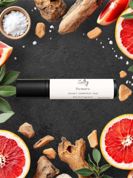 Sultry Scents wood sage and sea salt inspired roll on fragrance bottle surrounded by grapefruit slices and sea salt
