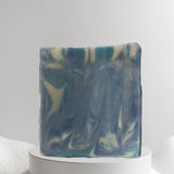 Sultry Scents Wood Sage & Sea Salt inspired soap with blue and cream marbled design on white pedestal